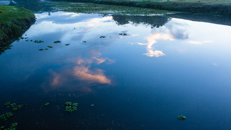 Water pond dawn sun sky color mirror glass reflections scenic landscape.