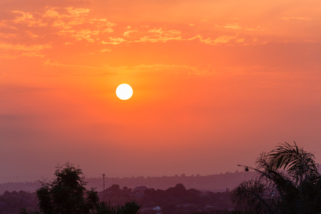 Sun haze in high clouds at sunset over the summer landscape.の写真素材