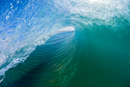 Ocean wave surfer surfing hollow view tube ride inside outward water photo.の写真素材