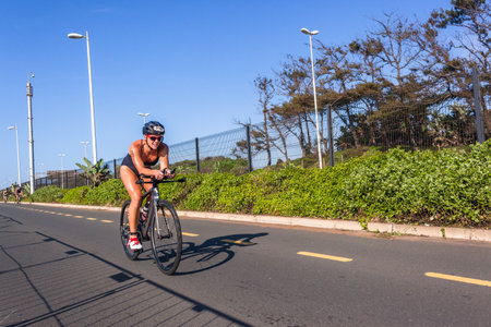 Triathlon National Champs Durban, South-Africa - March 24 , 2019 :  Athleteswoman cycling road course close-up action second leg of triathlon raceのeditorial素材