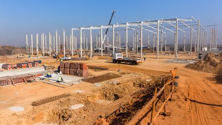 Industrial construction on site of new warehouse factory buildings been erected with concrete...