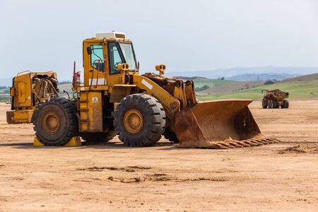 Industrial construction dump truck tipper bin moves earth on new industrial property earthworks...