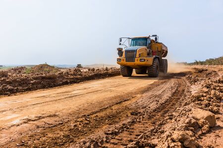 Industrial construction dump truck tipper bin moves earth on new industrial property earthworks...