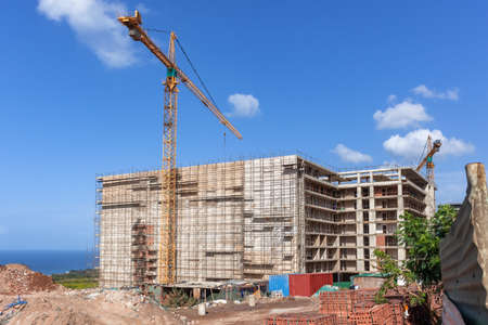 New building construction halfway about eight floors steel scaffolding and cranes with outer window...