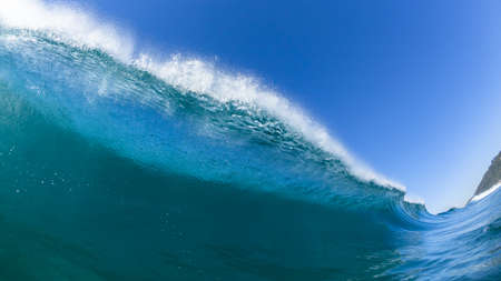 Ocean sea wave encounter swimming closeup water photo of blue water crashing breaking toward beach coastline.の写真素材