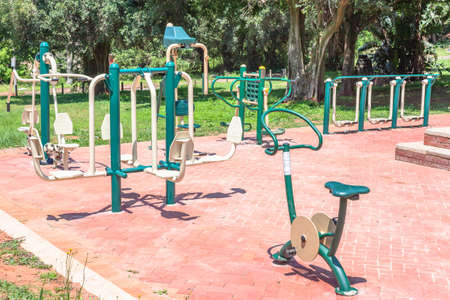 Fitness gym machines setup outdoors park summer green layout for healthy training exercise for public .の写真素材