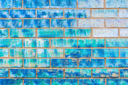 Wall closeup clay bricks plaster painted assorted of blue colors abstract background outdoors.