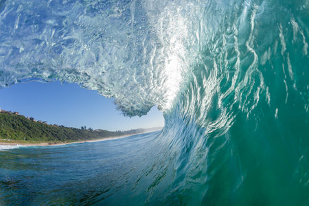Ocean Wave surfing tube ride perspective swimming Close-up encounter inside hollow water power.の写真素材