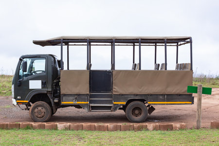 Safari truck vehicle with open seats for dozen plus persons parked empty used for animal drives to view wildlifeの写真素材