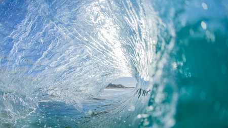 Wave surfing surfer tube ride view inside out hollow crashing blue water swimming water photoの写真素材