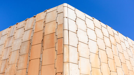 Construction New Concrete Retaining inter locking wall corner set in position a closeup on large puzzle pieces against blue sky.の写真素材