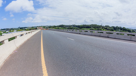 Driving road highway overhead ramps through construction expansion improvements with barriers, earthworks, new lanes for vehicle traffic flow landscape.の写真素材