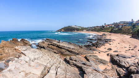 Scenic view overlooking photograph of Thompsons Bay beach rocky coastline with blue sea water, a holiday destination.の写真素材