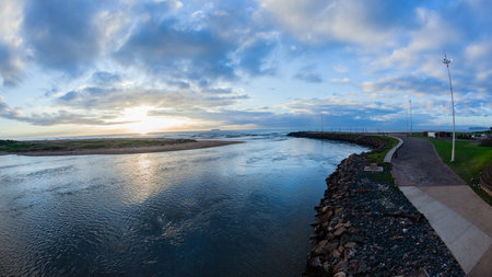 Morning overview from bridge crossing of Umgeni River mouth waters flowing into Indian Ocean beach coastline landscape just north of  Durban Cityの写真素材