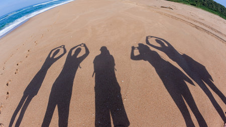 Man women outlines walking beach ocean waters-edge sign love gestures shadow images on the sand...