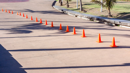 Sports event equipment with orange marker cones for track course direction layout for athletesの写真素材