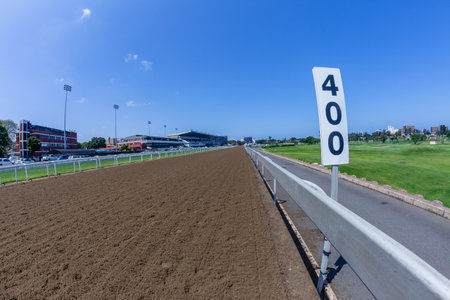 Horse racing track inside railing on a clear blue day