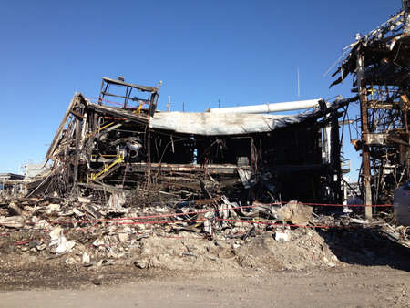 partially demolished structure at asbestos cleanup site