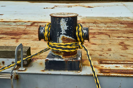 A cruciform bollard with mooring rope for securing a boat