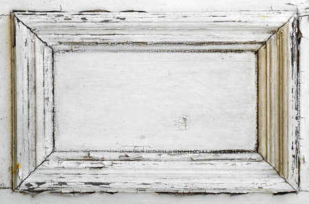 A white door panel with old weathered and cracked paint