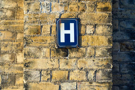 The letter H on a sign on a wallの写真素材
