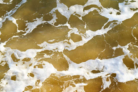 Brown sea water abstract with white bubbles