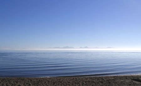 A flat-calm sea at dawnの写真素材