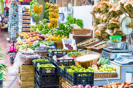 vibrant colors and lively atmosphere of the Mercado dos Lavradores in Funchal, Madeira, showcasing fresh produce, exotic fruits, and bustling market activityの写真素材
