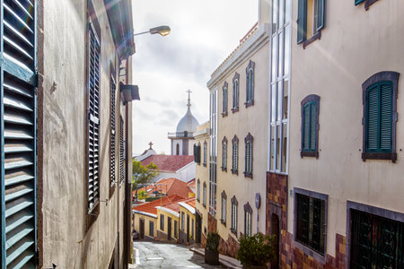 Historic alley in Funchal with the Church of Saint Mary the Great in the background (Madeira, Portugal)の写真素材