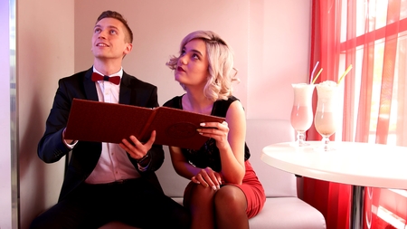 Guy and girl talk with a waiter