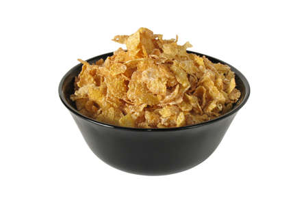 corn flakes on a black dish isolated on white background. 