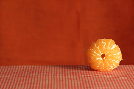 Still life with one peeled mandarin on a brown background  Low key  Studio shot の写真素材