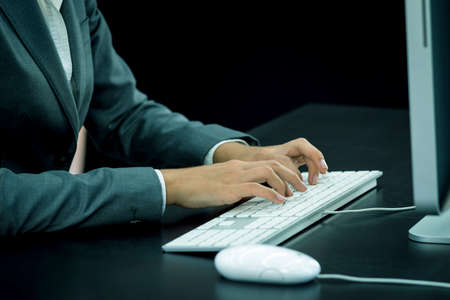 Businesswoman typing at computerの写真素材