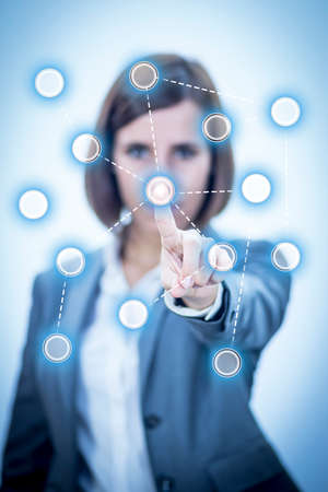Businesswoman touching Screen Concept Networksの写真素材