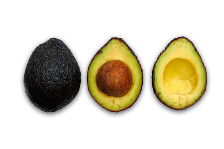 Whole and cut in half black avocado isolated on white background. Top view.の写真素材