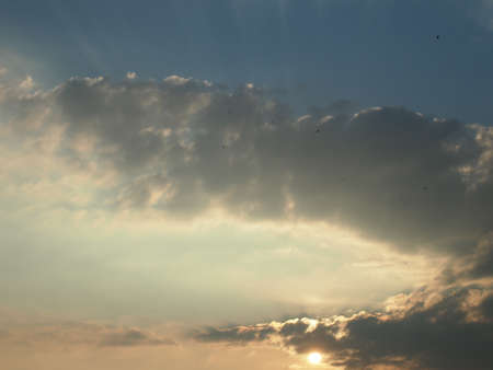 Sunrise behind the cloud with reflectionの写真素材