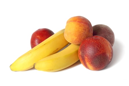 group of ripe peaches and bananas isolated on whiteの写真素材