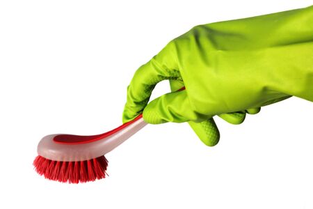 Hand in green glove with red brush isolated on white backgroundの写真素材