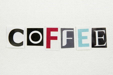 coffee word cut from newspaper on white handmade paper の写真素材