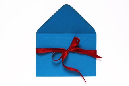 open blue envelope tied with red ribbon and bow の写真素材