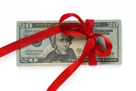 dollars tied with red ribbon isolated on white の写真素材