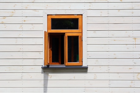 an open window on white wooden wall 