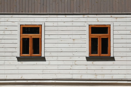 two windows on white wooden wall  の写真素材
