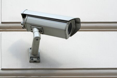 security camera on white wall 