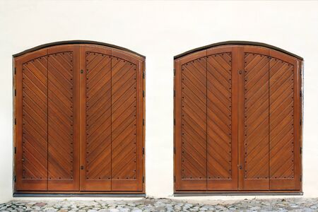 Two wooden entrance gate on white wallの写真素材