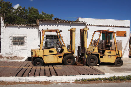 Two rusty forklifts in Port of Kissamos- Creteの写真素材
