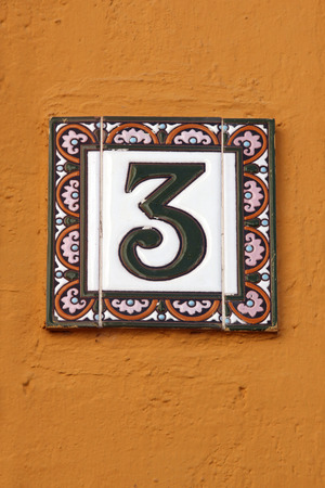 number three house address plate number on orange wall の写真素材