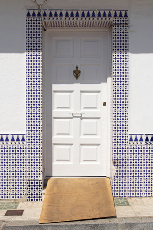 White door with spanish azulejosの写真素材