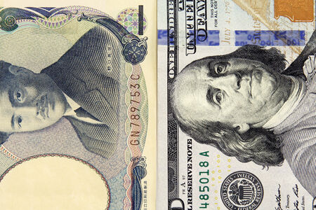 closeup of american dollar and yen- concept of currency exchange