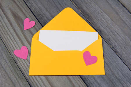 love letter- yellow envelope with paper heartの写真素材